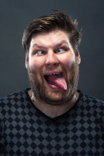 Bearded man showing his tongue — Stock Photo, Image