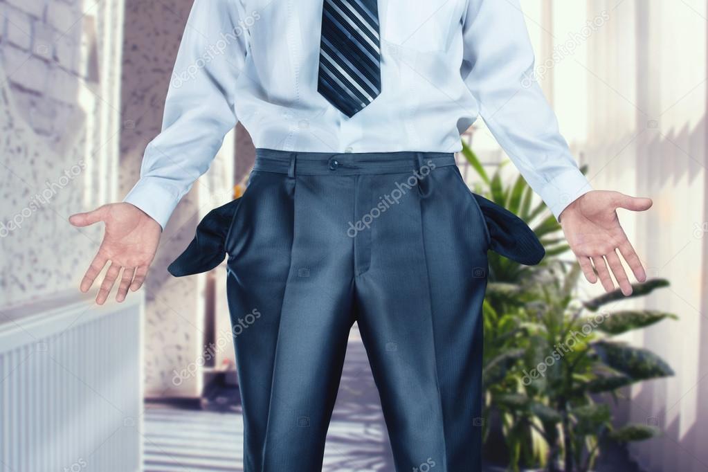 Businessman pulling out empty pockets