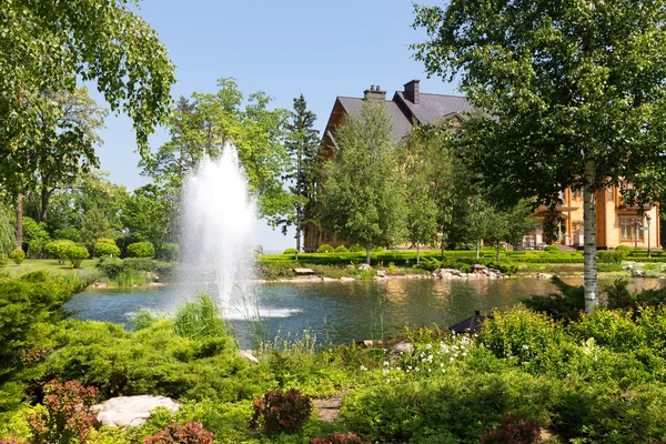 Green spring park with fountain — Stock Photo, Image