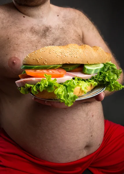 Male belly with sandwich — Stock Photo, Image