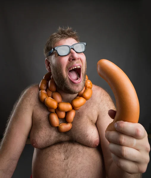 Hungry man with sausages — Stock Photo, Image