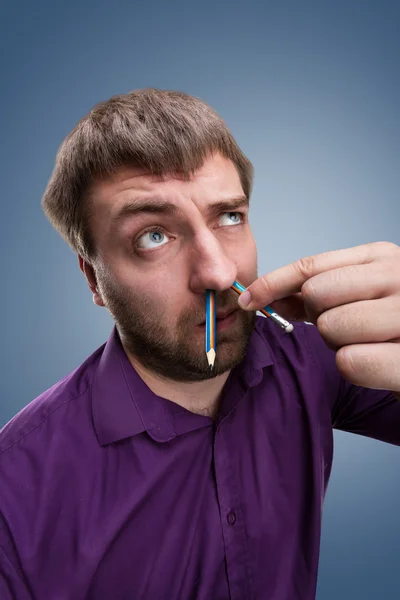 Man with pencil in the nose — Stock Photo, Image