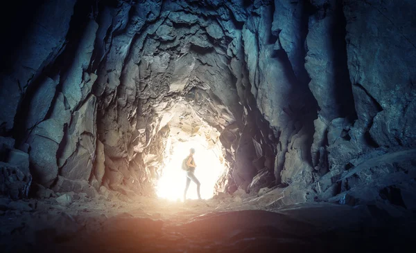 Woman hiker in  cave — Stock Photo, Image