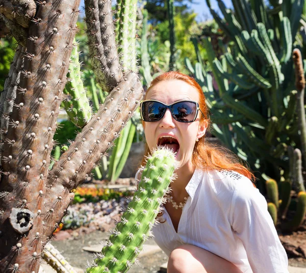 Frau mit Sonnenbrille beißt Kaktus — Stockfoto