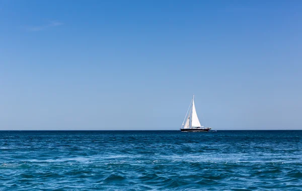 Vitorlás hajó az óceán kék ég alatt — Stock Fotó