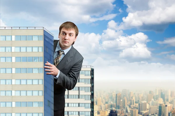 Businessman near skyscrapers — Stock Photo, Image