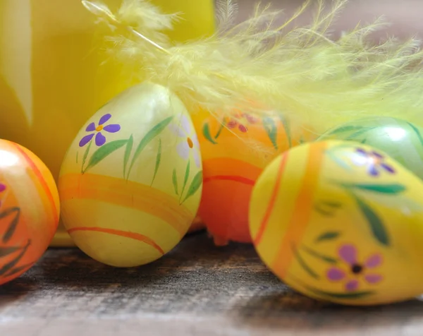 Easter eggs under feather — Stock Photo, Image
