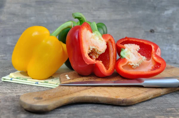 Fresh peppers on plank — Stock Photo, Image