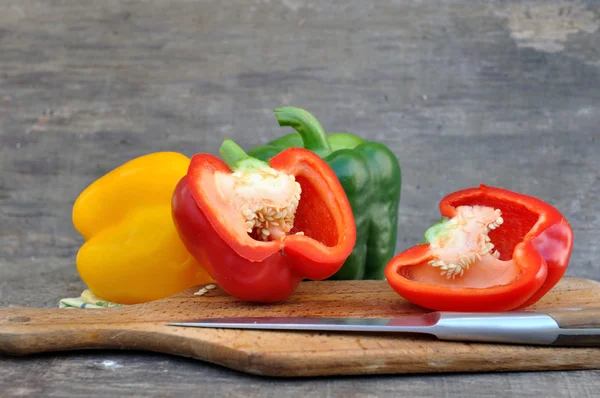 Fresh peppers on a wooden plank — Stock Photo, Image