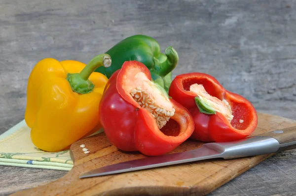 Fresh peppers on wooden plank — Stock Photo, Image