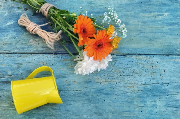 Pretty flowers on blue plank — Stock Photo, Image