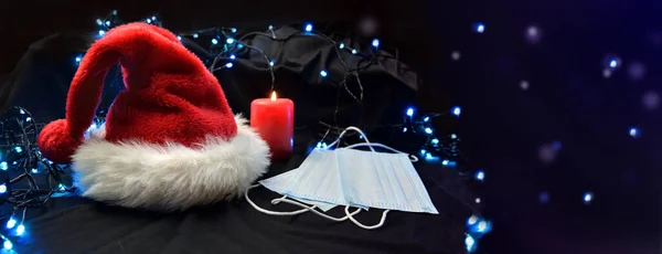 Face Masks Put Next Red Santa Claus Hat Candle Blur — Stock Photo, Image