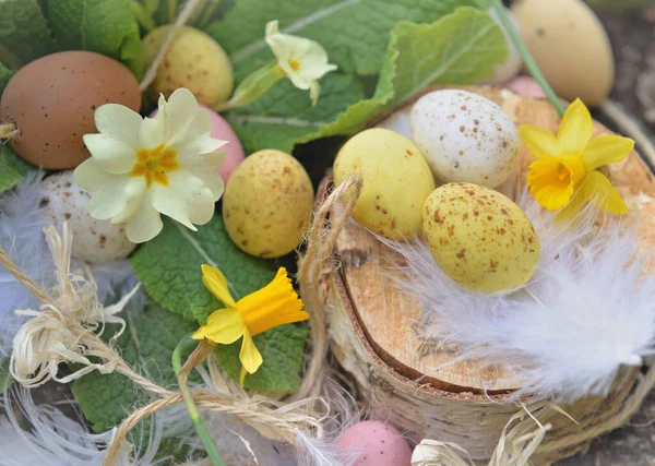 close on decorative easter eggs hidden  in spring flowers in the garden