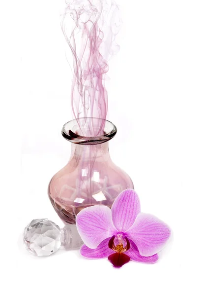 Perfume bottle spraying colorful scent — Stock Photo, Image
