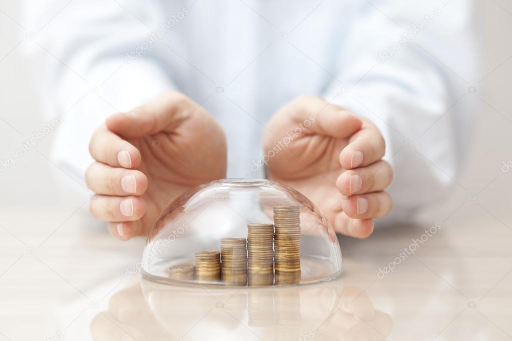 Rising coins protected under a glass dome and hands 