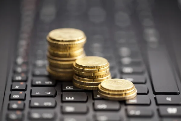 Rising coins on keyboard — Stock Photo, Image
