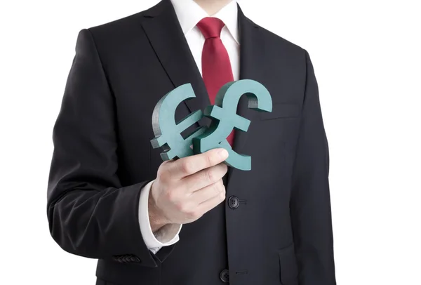 Businessman holding euro and pound signs with clipping path — Stock Photo, Image