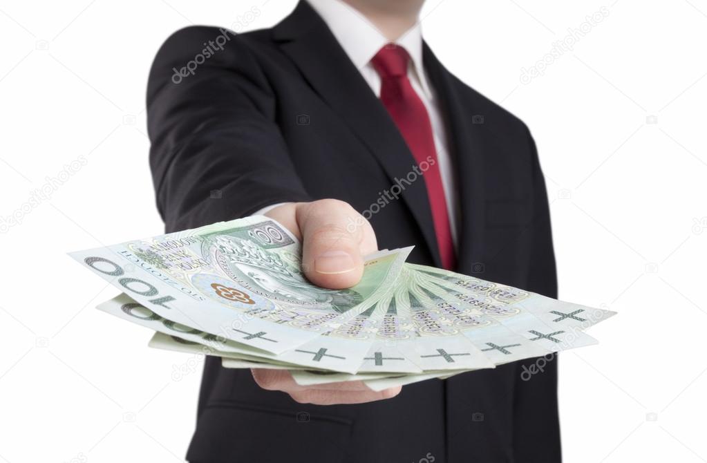 Businessman holding polish money. Clipping path included.