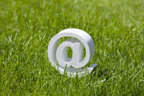 Email sign on green grass — Stock Photo, Image