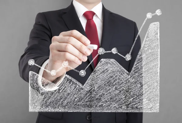 Businessman drawing a graph with chalk. — Stock Photo, Image