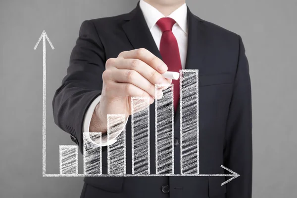 Businessman drawing a growing chart with chalk. — Stock Photo, Image