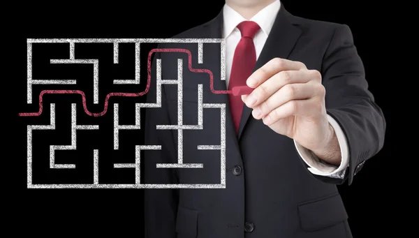 Businessman finding the solution of a maze — Stock Photo, Image