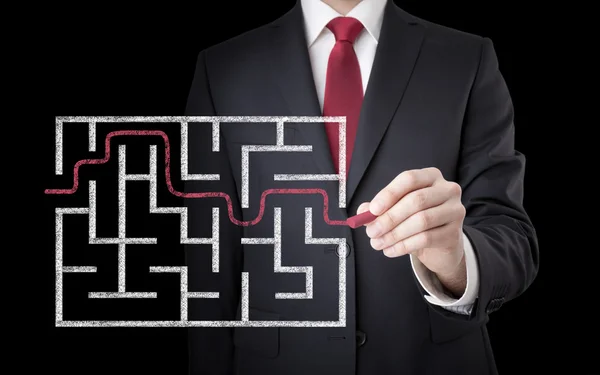Businessman finding the solution of a maze — Stock Photo, Image
