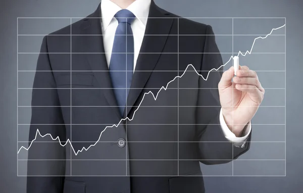 Businessman drawing a growing chart with chalk — Stock Photo, Image