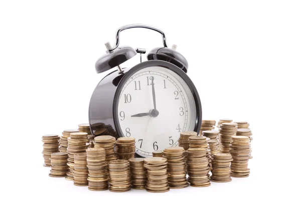 Time is money. Alarm clock with stacks of coins. Clipping path included. — Stock Photo, Image