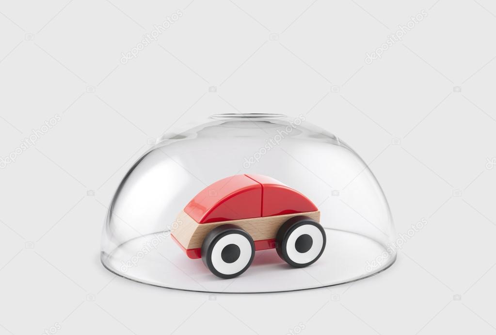 Toy car protected under a glass dome