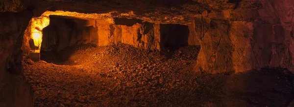 Interior panorama of underground mine shaft. Dark corridors inside abandoned stone quarry