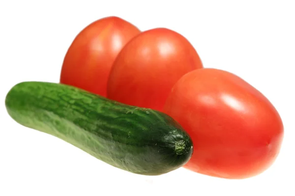 Cucumber and three tomatoes — Stock Photo, Image