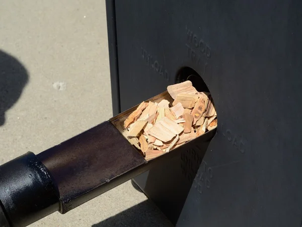 Putting Wood Chips in a Smoker — Stock Photo, Image