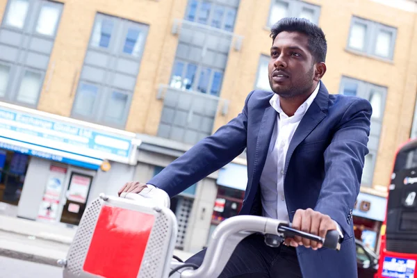 Indian business man using a hire bike — Stock Photo, Image