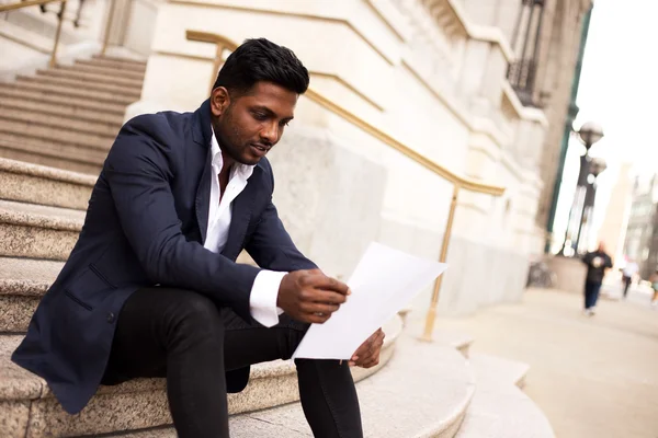 Indian business man reading a letter — Stock Photo, Image