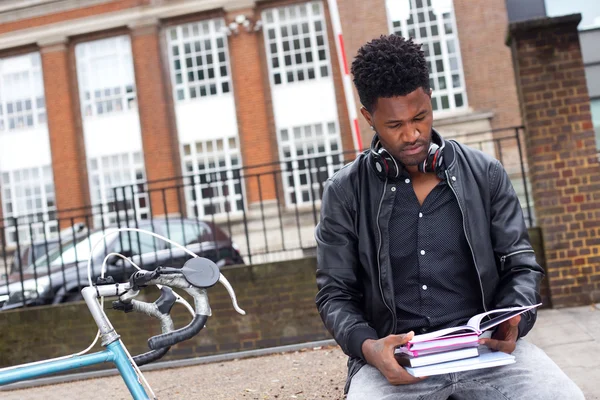 Young man reading his textbooks — Stock Photo, Image