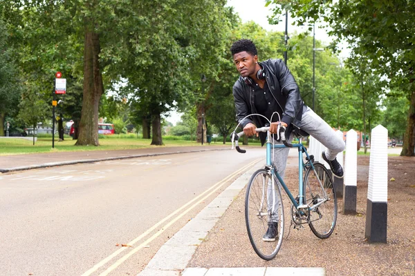 A yoiung man with his bike — Stock Photo, Image