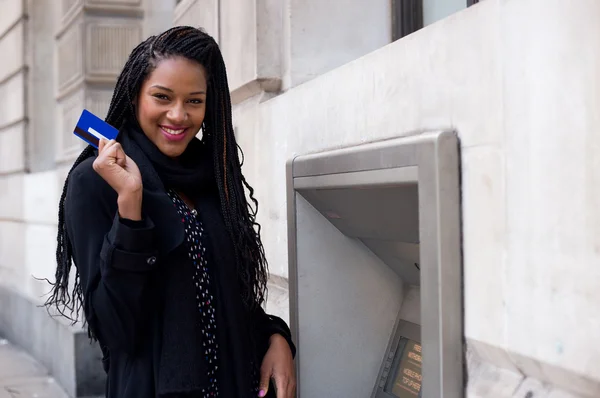 Woman holding cash card at atm. — Stock Photo, Image