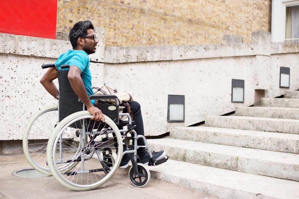 A young indian man in a wheelchair