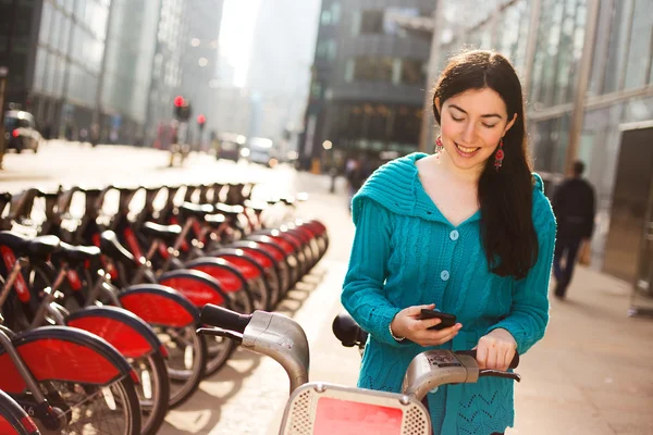 Young woman with a hire bike — Stock Photo, Image
