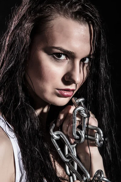 Portrait of a beautiful young woman with a steel chain