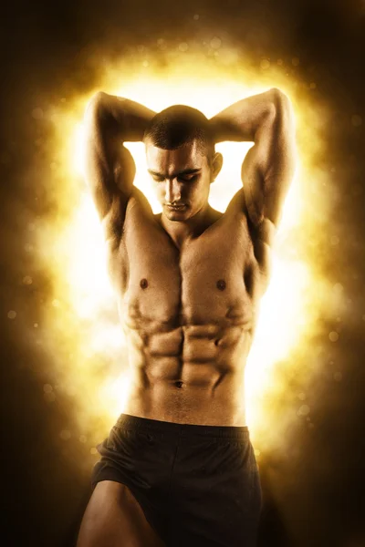 Fitness man on black with fire — Stock Photo, Image