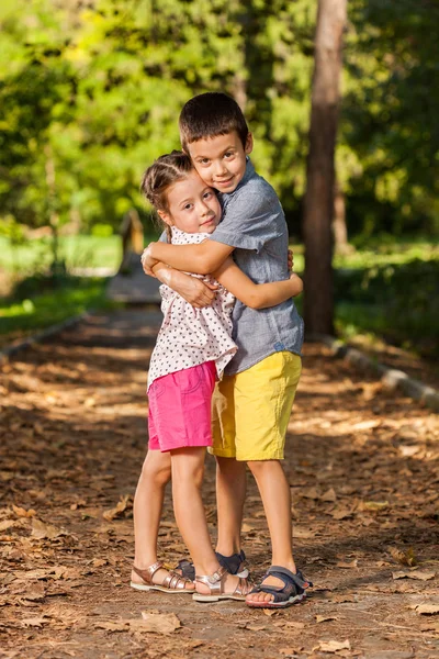 Happy sister and brother together in the park — Stock Photo, Image