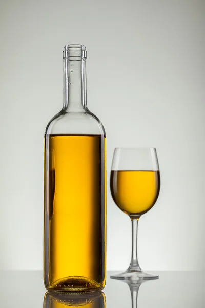 Wine in glass and bottle of wine on white — Stock Photo, Image