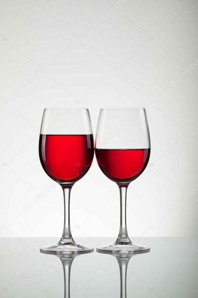 Wine in glass and bottle of wine on white