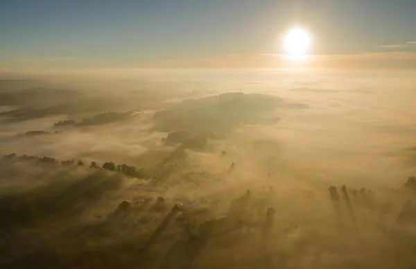 Sunrise over the misty fall landscape from the air — Stock Photo, Image