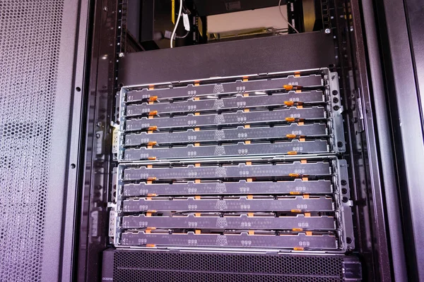 close-up of a server with trays filled with hard disks inside internet cloud center