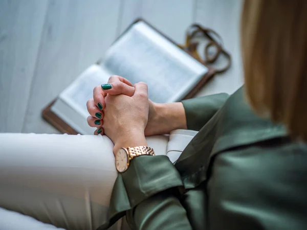 View of a woman reading a Bible