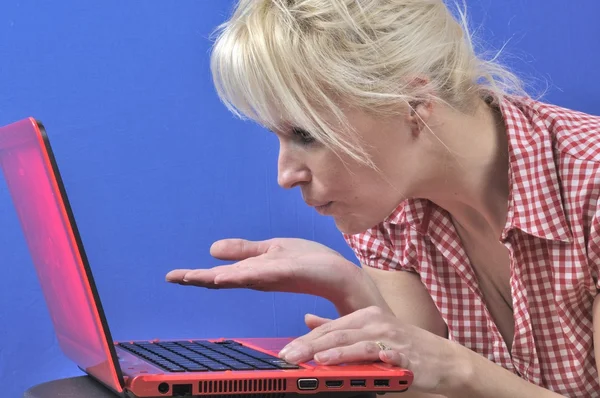 Woman blowing a kiss with notebook computer — Stock Photo, Image