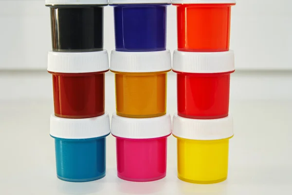 Jars with colorful paint — Stock Photo, Image
